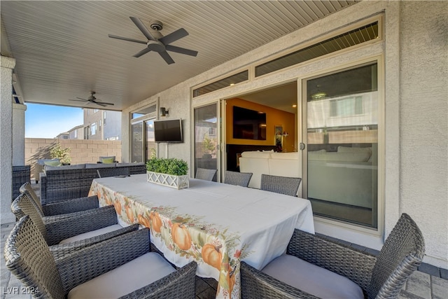 view of patio / terrace with ceiling fan and an outdoor bar