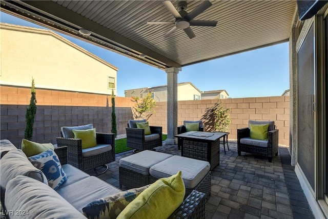 view of patio / terrace with an outdoor living space with a fire pit and ceiling fan