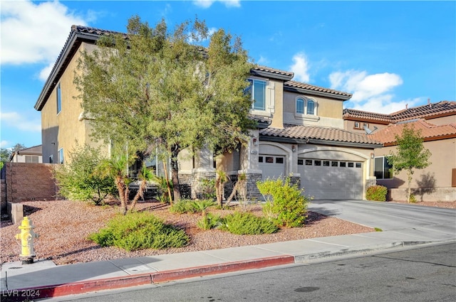 mediterranean / spanish house featuring a garage