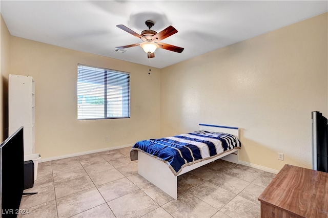 bedroom with ceiling fan and light tile patterned floors