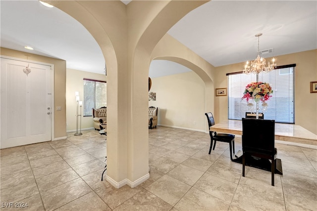 tiled dining space featuring a chandelier