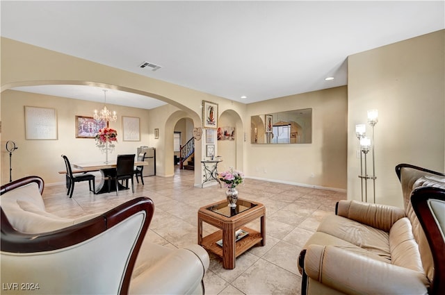 living room with a chandelier and light tile patterned flooring