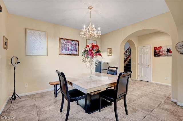 dining area with an inviting chandelier