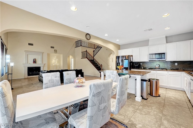 tiled dining room with lofted ceiling