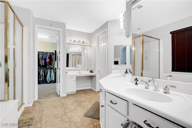 bathroom with tile patterned flooring, vanity, and an enclosed shower