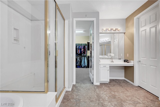 bathroom featuring vanity and a shower with shower door