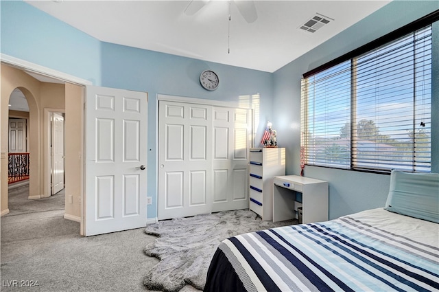 bedroom with light carpet, a closet, and ceiling fan