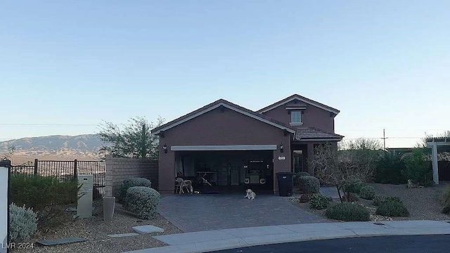 view of front of property with a mountain view and a garage