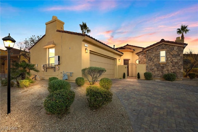 mediterranean / spanish-style house with a garage