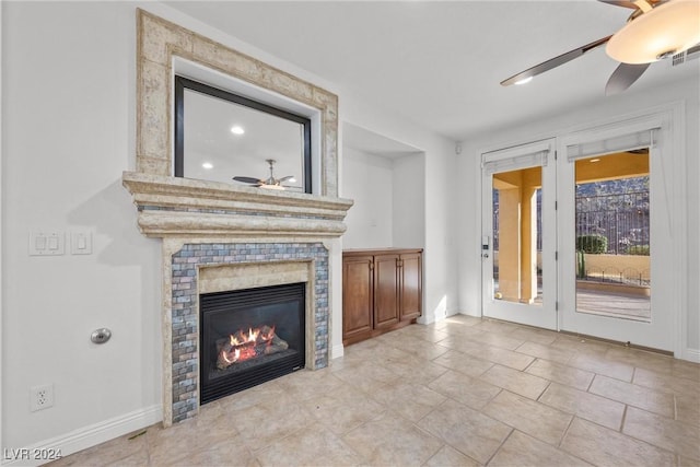 unfurnished living room featuring ceiling fan and a large fireplace