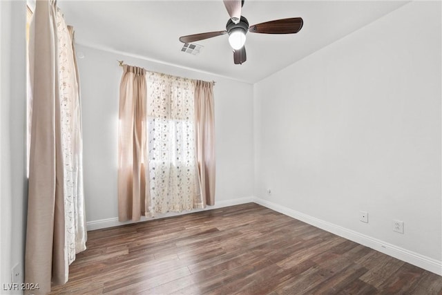 unfurnished room featuring ceiling fan and dark wood-type flooring