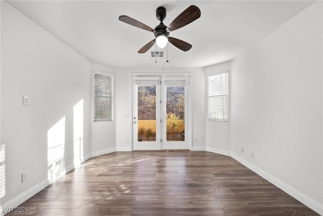 unfurnished room with ceiling fan and dark hardwood / wood-style flooring