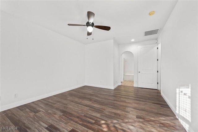 unfurnished room featuring ceiling fan and dark wood-type flooring