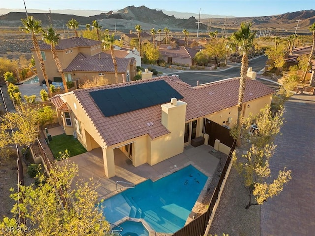 view of swimming pool with a mountain view and a patio