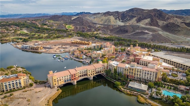 drone / aerial view with a water and mountain view