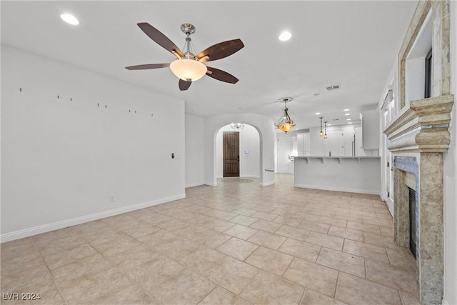 unfurnished living room with ceiling fan