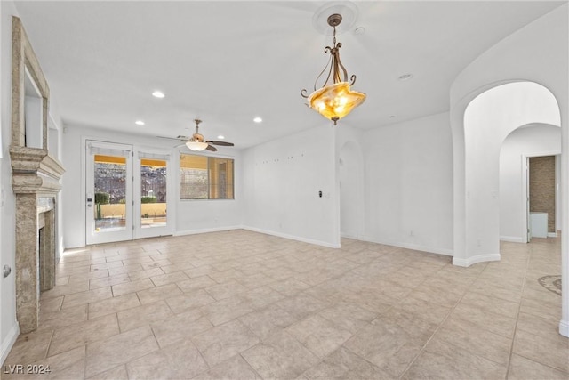 unfurnished living room with ceiling fan