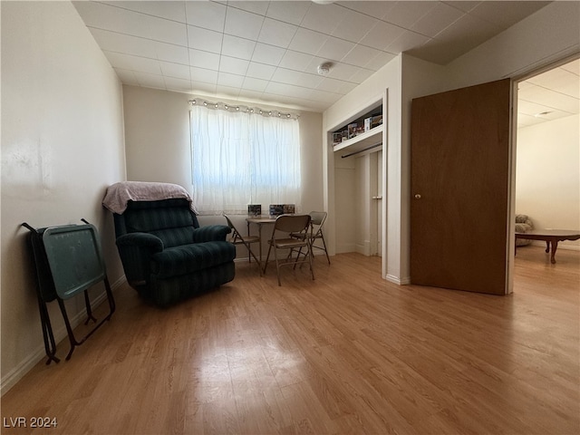 sitting room with wood-type flooring