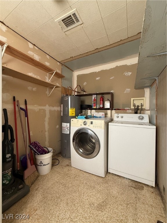 laundry room with separate washer and dryer and water heater