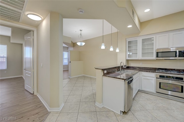 kitchen with white cabinetry, sink, stainless steel appliances, kitchen peninsula, and decorative light fixtures