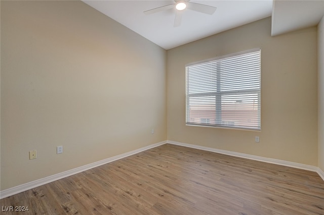 empty room with ceiling fan and light wood-type flooring