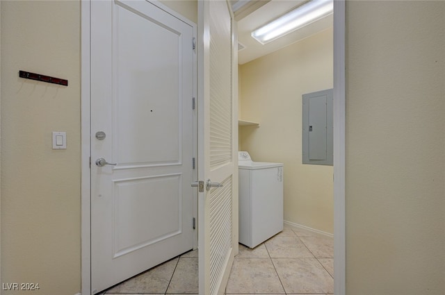 clothes washing area featuring washer / clothes dryer, light tile patterned floors, and electric panel