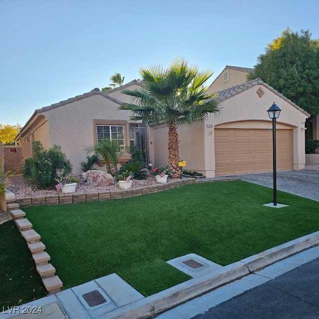 view of front facade with a garage and a front yard