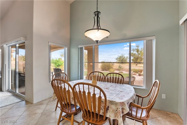 tiled dining space with a high ceiling