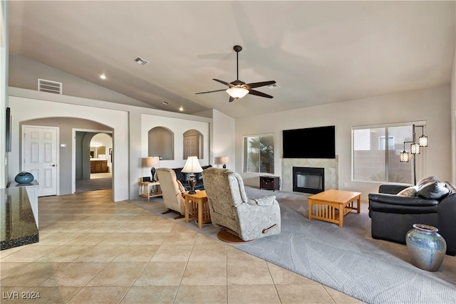 living room with ceiling fan, light tile patterned floors, and vaulted ceiling