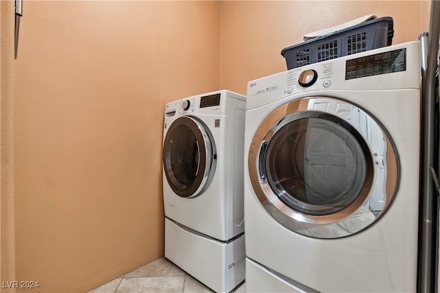 laundry area with light tile patterned floors and independent washer and dryer