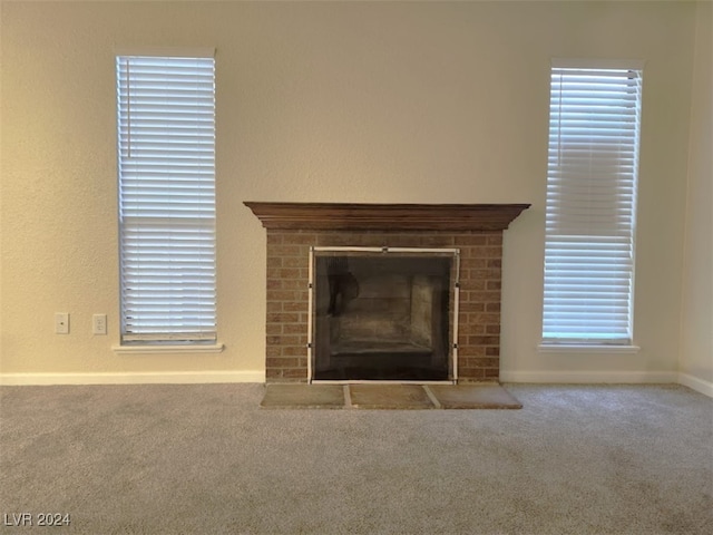 interior details featuring carpet floors and a brick fireplace