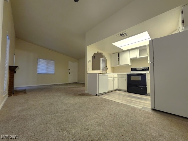 kitchen featuring lofted ceiling, white cabinetry, light carpet, and white appliances