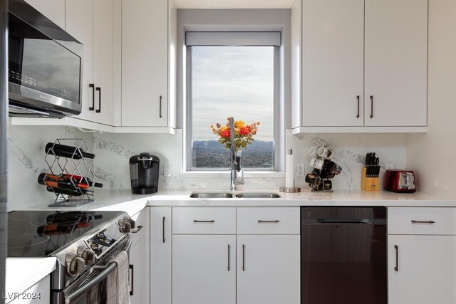 8255 Las Vegas Blvd Unit 2002, Las Vegas, NV 89123 - kitchen with stainless steel appliances, a sink, white cabinetry, and light countertops