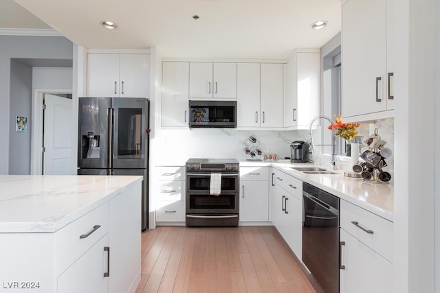 8255 Las Vegas Blvd Unit 2002, Las Vegas, NV 89123 - kitchen with appliances with stainless steel finishes, a sink, tasteful backsplash, white cabinets, and ornamental molding