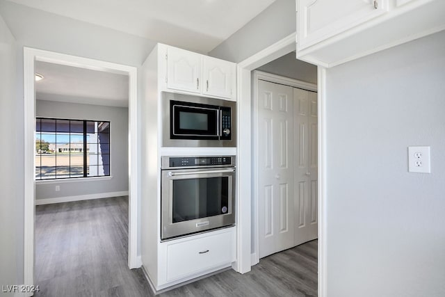 kitchen with white cabinetry, light hardwood / wood-style floors, and appliances with stainless steel finishes