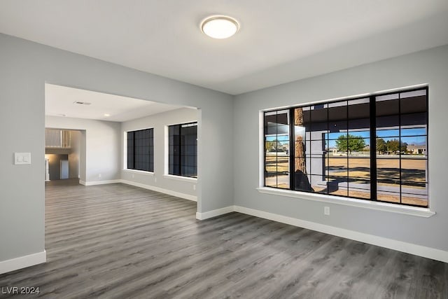 unfurnished room with hardwood / wood-style floors