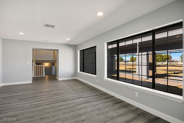 unfurnished room with dark hardwood / wood-style flooring