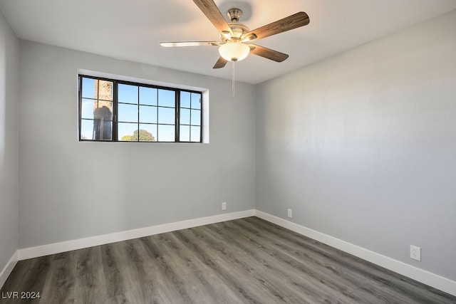 spare room with ceiling fan and dark wood-type flooring