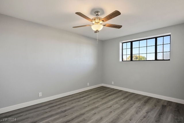 unfurnished room with ceiling fan and dark hardwood / wood-style flooring