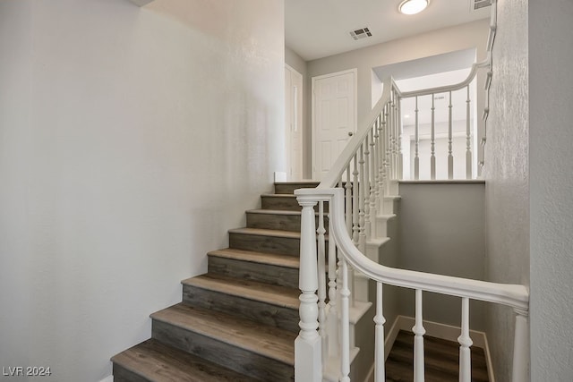 stairway featuring wood-type flooring