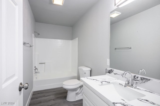 full bathroom with bathing tub / shower combination, toilet, vanity, and hardwood / wood-style flooring