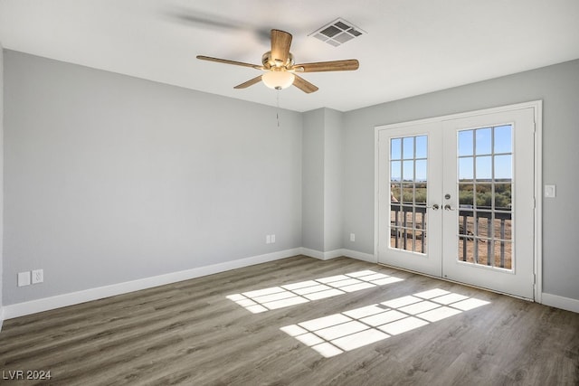 spare room with french doors, ceiling fan, and hardwood / wood-style floors