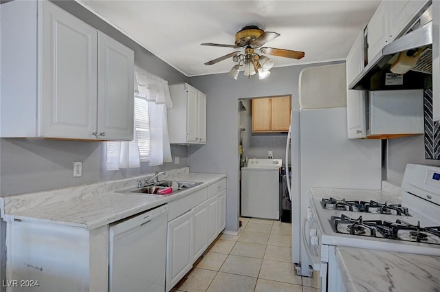 kitchen with washer / dryer, white appliances, white cabinetry, and extractor fan