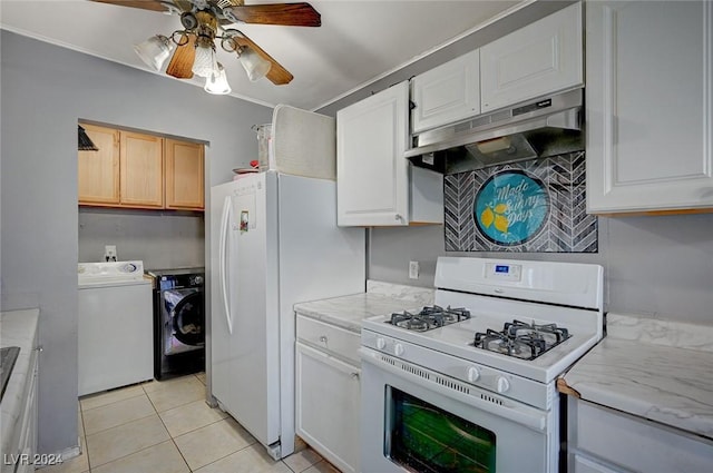 kitchen with white appliances, ceiling fan, light tile patterned floors, independent washer and dryer, and white cabinetry