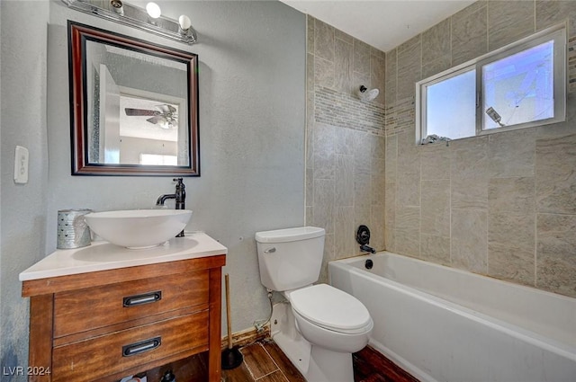 full bathroom with toilet, vanity, tiled shower / bath combo, and hardwood / wood-style flooring