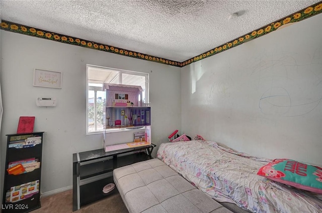 bedroom featuring carpet and a textured ceiling