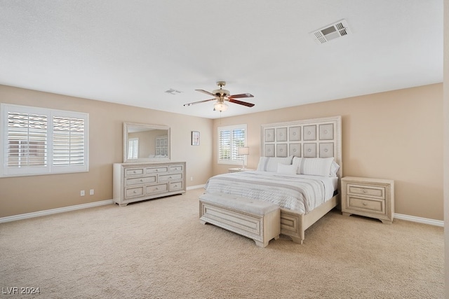 bedroom with light colored carpet and ceiling fan