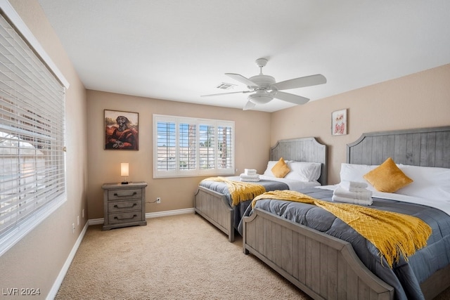 bedroom with ceiling fan and light carpet