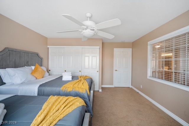 carpeted bedroom featuring a closet and ceiling fan