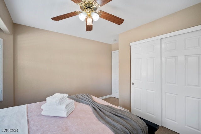 bedroom featuring ceiling fan, a closet, and carpet